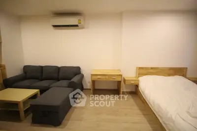 Cozy studio apartment with modern furniture and air conditioning, perfect for urban living.