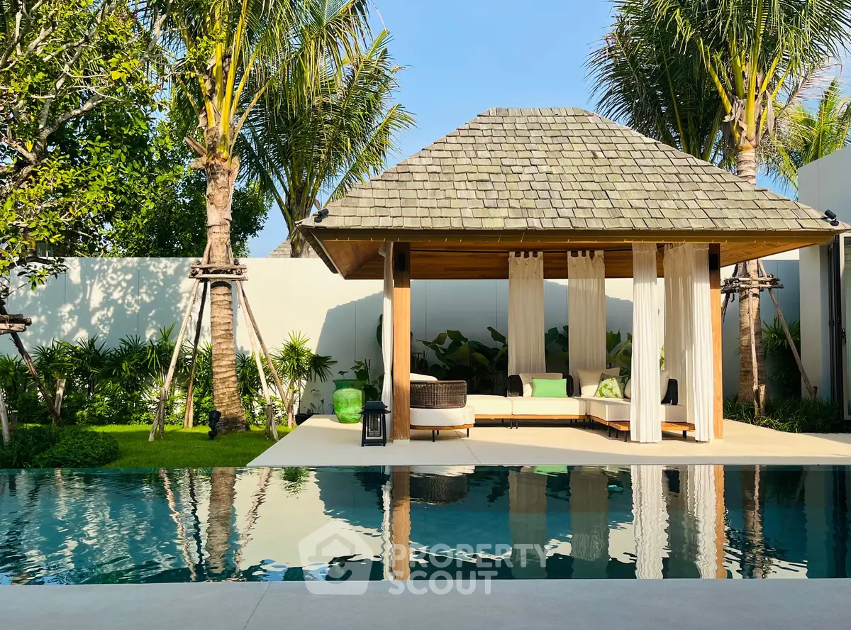 Luxurious tropical poolside cabana with lush greenery and serene ambiance, perfect for relaxation and entertaining.