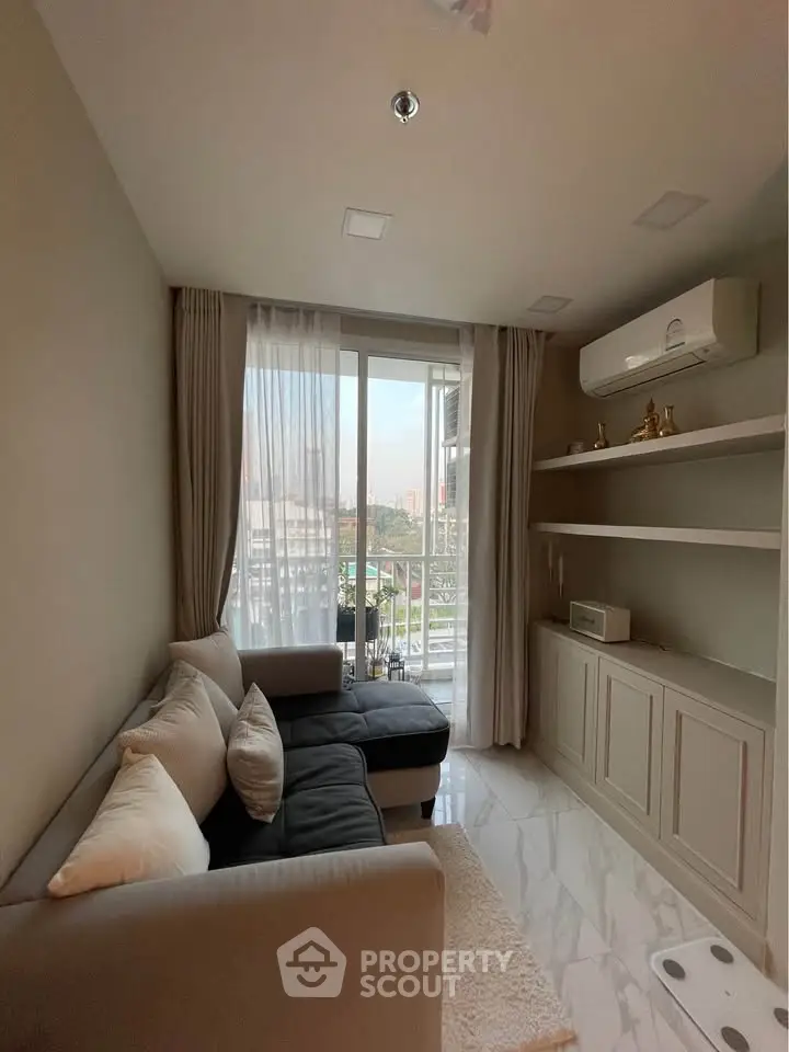 Cozy living room with modern sofa and large window offering city view