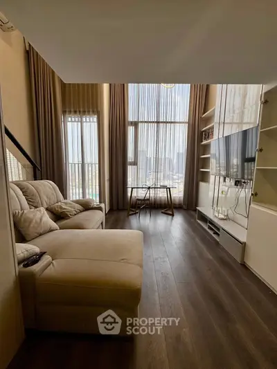Luxurious living room with high ceilings and city view, featuring elegant furniture and modern decor.