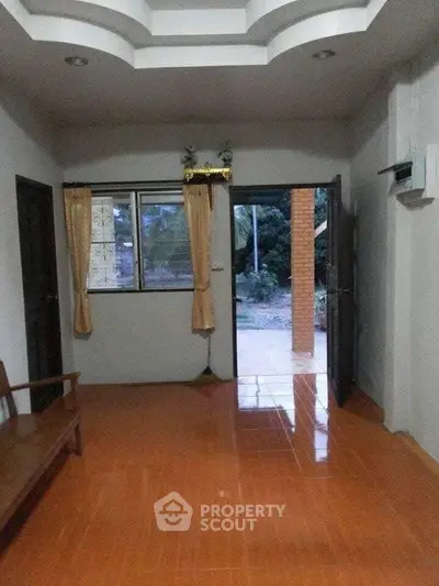 Cozy living room with open door leading to outdoor patio area.