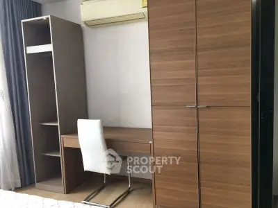 Modern study area with wooden desk and wardrobe in a stylish apartment.