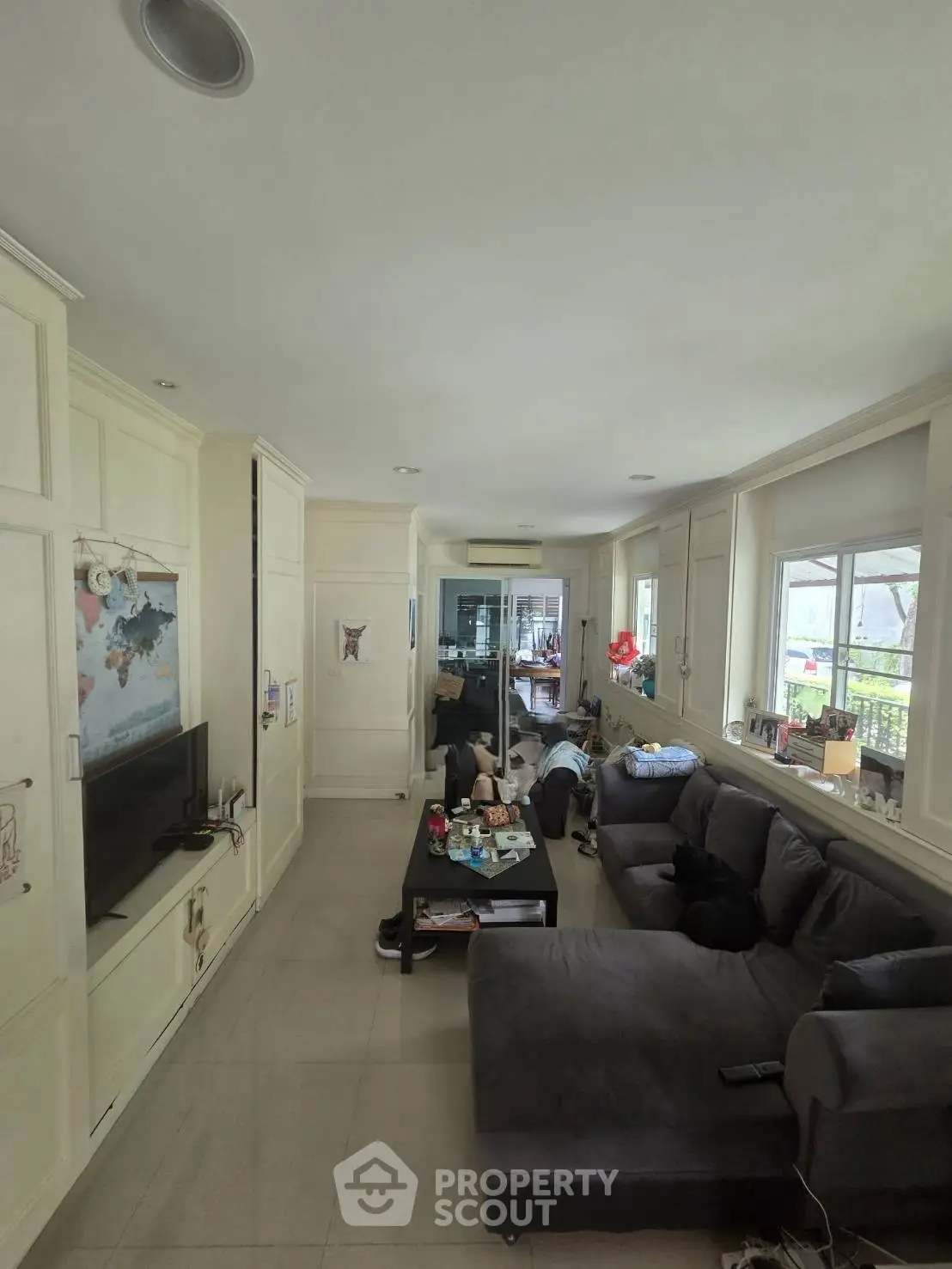 Spacious living room with modern decor and large windows for natural light