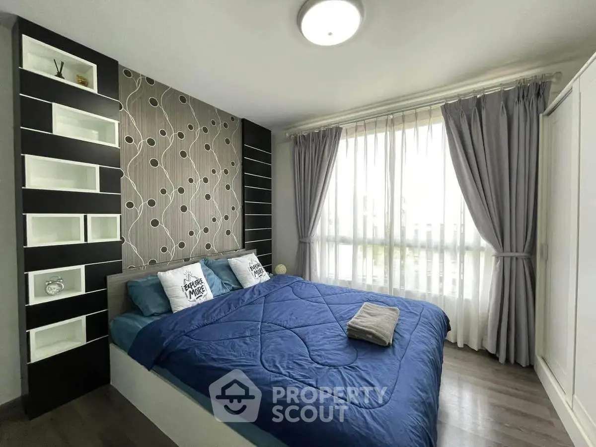 Modern bedroom with stylish decor and large window for natural light