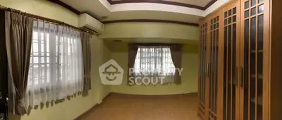 Spacious room with wooden flooring and large wardrobe, perfect for a cozy bedroom setup.