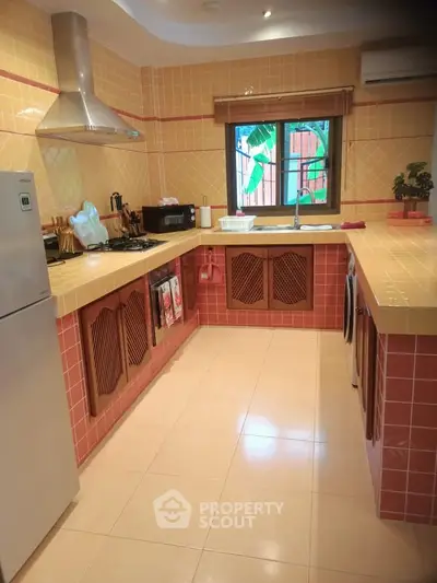 Charming kitchen with vibrant tiles and modern appliances, featuring a gas stove and ample counter space.