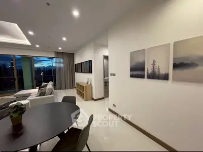 Modern living room with elegant decor and city view, featuring sleek furniture and ambient lighting.