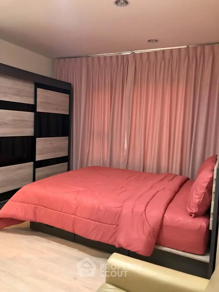 Cozy bedroom with modern decor and stylish curtains, perfect for relaxation.
