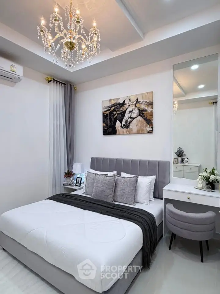 Luxurious bedroom with elegant chandelier and stylish decor