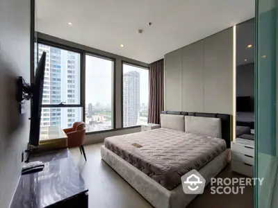 Modern bedroom with large windows and city view in high-rise apartment