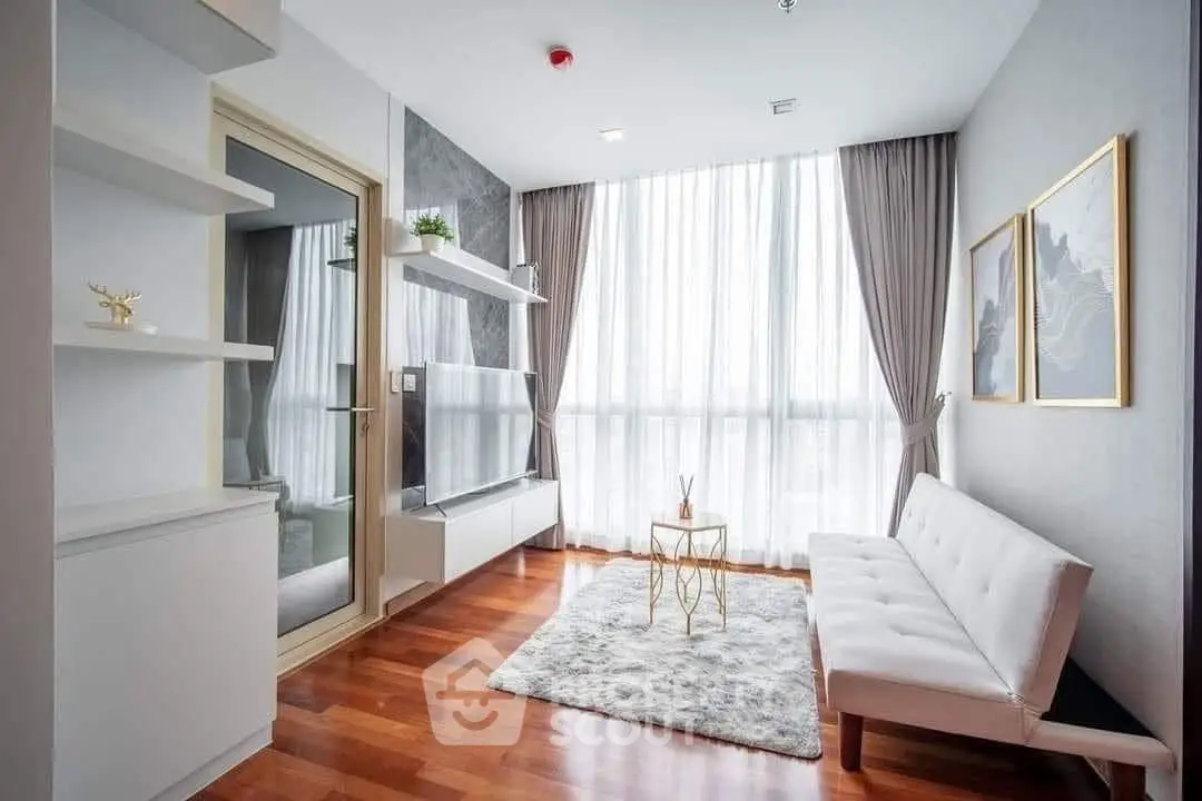 Modern living room with elegant decor, large window, and stylish furniture in a bright apartment.