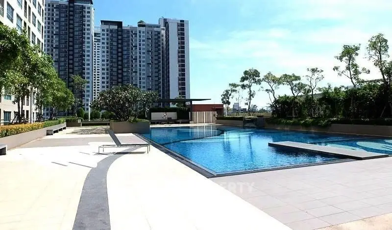 Luxurious residential complex with stunning pool and modern high-rise buildings.
