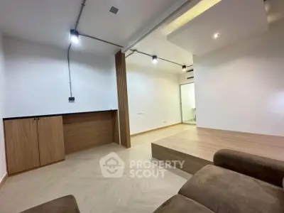 Modern minimalist living room with wooden flooring and recessed lighting