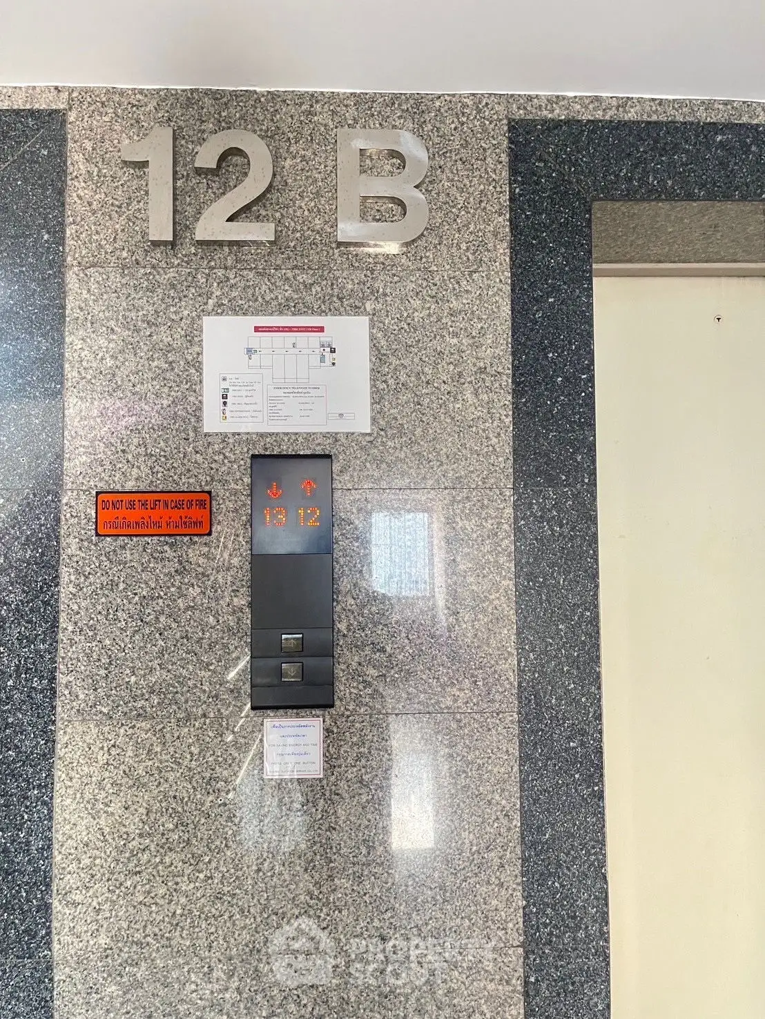 Modern elevator entrance with floor number signage in a residential building
