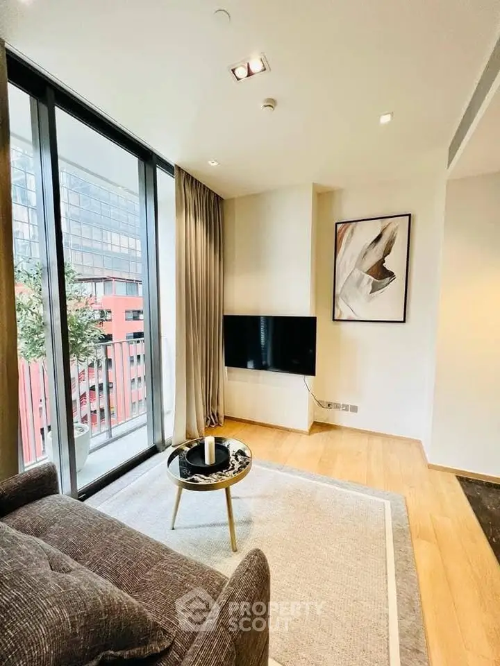 Modern living room with floor-to-ceiling windows and stylish decor in urban apartment.