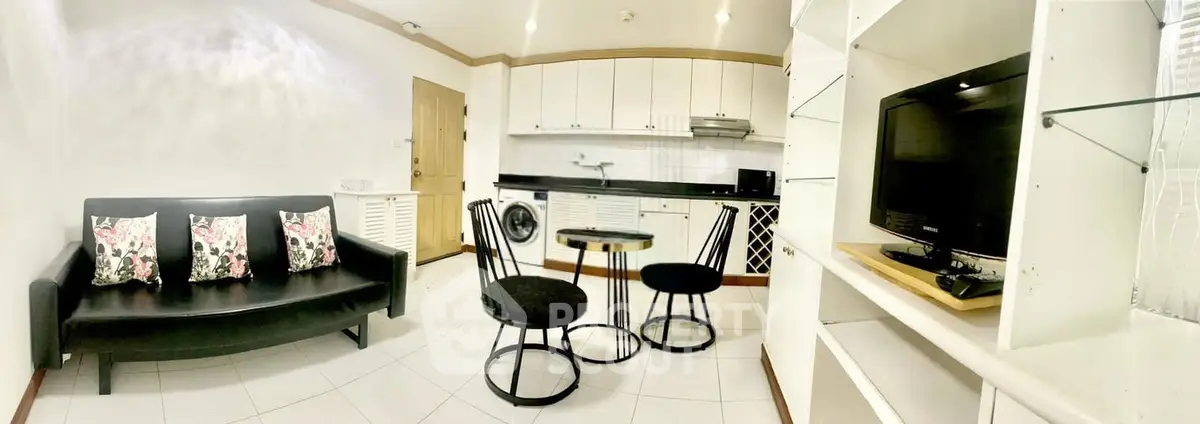 Chic open-layout living room with modern kitchen and cozy seating area, perfect for urban living.