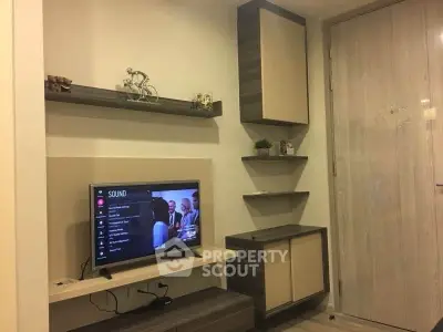 Modern living room with sleek shelves and mounted TV, perfect for cozy entertainment.