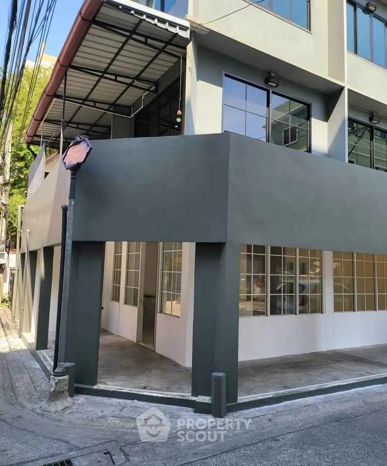 Modern commercial building exterior with large windows and sleek design