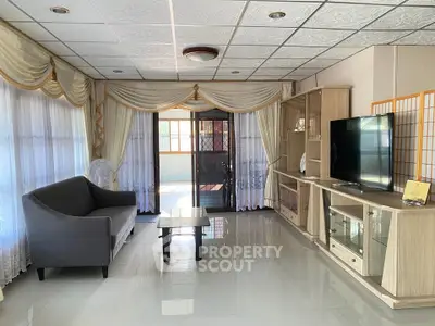 Spacious living room with elegant decor and large windows for natural light.