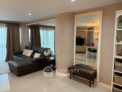 Spacious living room with modern decor and large windows in a stylish apartment.