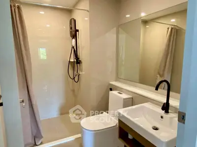 Modern bathroom with sleek fixtures and spacious shower area