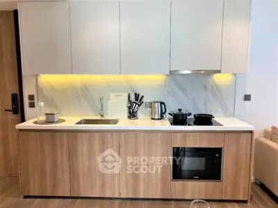 Modern kitchen with sleek cabinetry and built-in appliances in a stylish apartment.