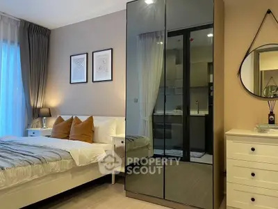 Modern bedroom with stylish decor and mirrored wardrobe