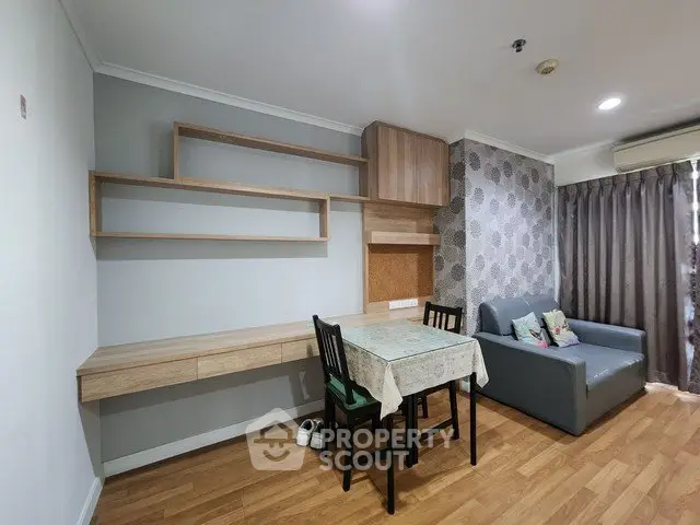 Cozy living room with modern decor, wooden flooring, and stylish furniture, perfect for relaxation and entertainment.