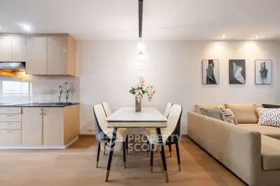 Modern open-plan living room with stylish dining area and cozy sofa