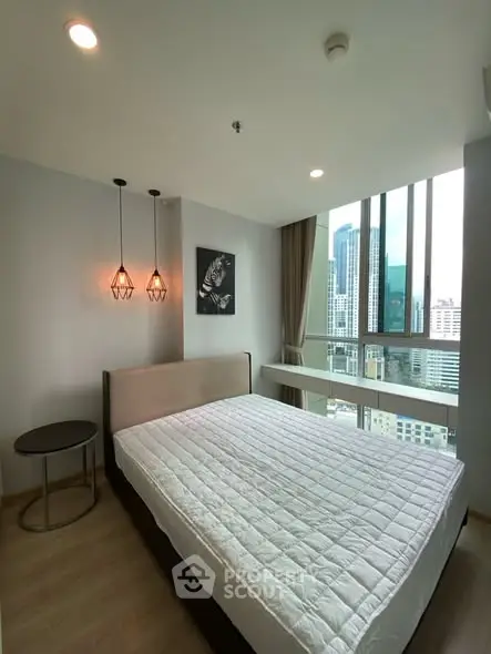 Modern bedroom with city view and stylish lighting in high-rise apartment.