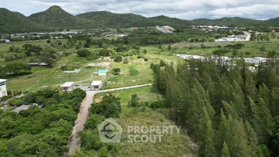 Expansive aerial view of lush green landscape with potential for real estate development.