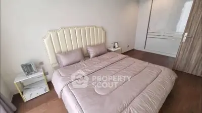 Luxurious bedroom with elegant decor and plush bedding in modern apartment.