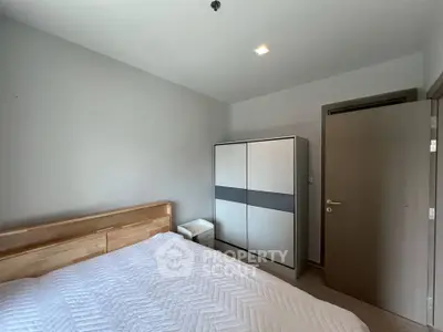 Modern bedroom with sleek wardrobe and cozy bed in minimalist design.