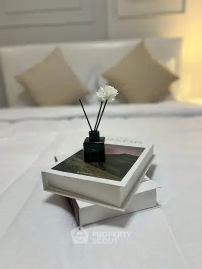 Elegant bedroom with stylish decor and cozy pillows on a pristine white bed.