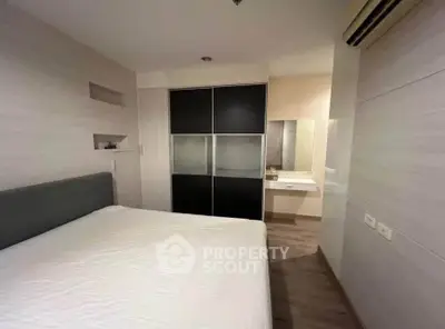 Modern bedroom with sleek design and built-in wardrobe in a stylish apartment.