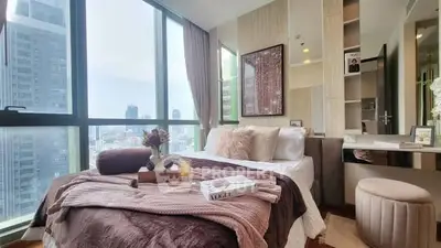 Luxurious bedroom with stunning city view and elegant decor in high-rise apartment.