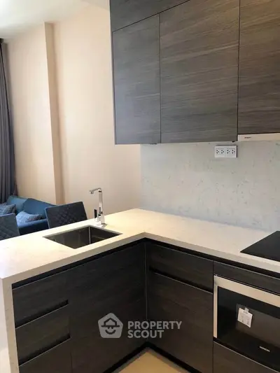 Modern kitchen with sleek cabinetry and integrated appliances in a stylish apartment.