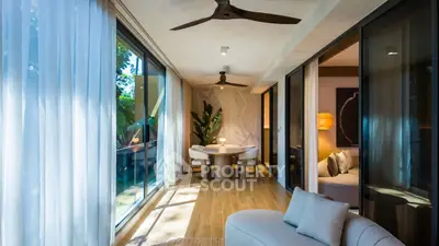 Luxurious living room with elegant decor and natural light, featuring a cozy seating area and stylish dining space.