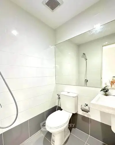 Modern bathroom with sleek white tiles and contemporary fixtures