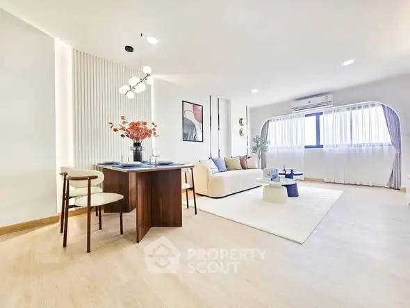 Spacious modern living room with elegant dining area and natural light