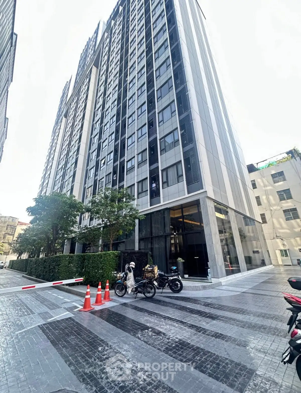 Modern high-rise building with sleek facade and street view