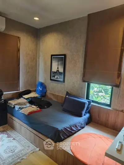 Cozy bedroom with modern decor and natural light, featuring a stylish bed and elegant wall art.