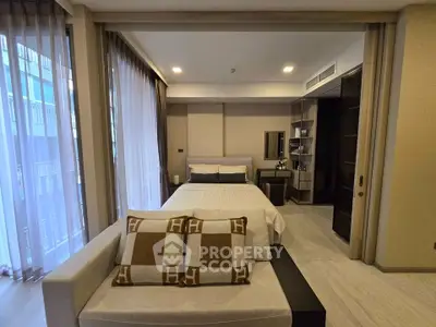 Luxurious bedroom with modern decor and large windows in a high-end apartment.