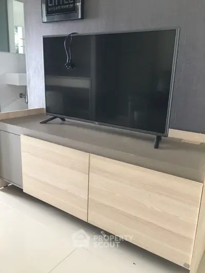 Modern living room with sleek TV on stylish wooden cabinet