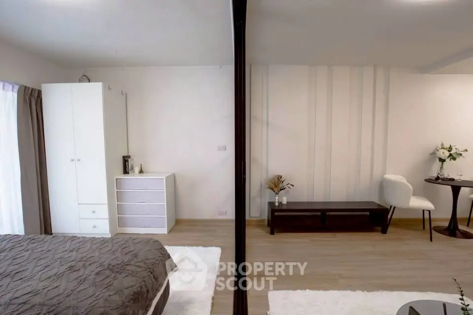 Modern bedroom with stylish decor and cozy ambiance, featuring a comfortable bed and elegant furniture.