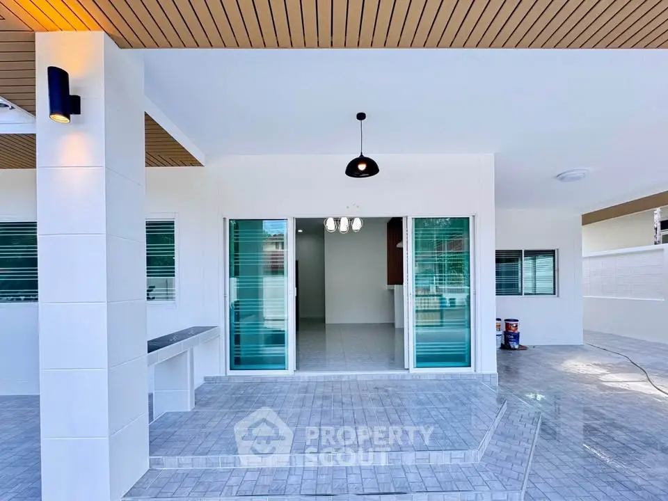Modern home entrance with stylish lighting and sliding glass doors
