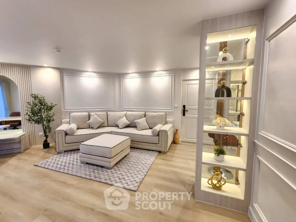 Luxurious living room with elegant decor and plush seating in a modern apartment.