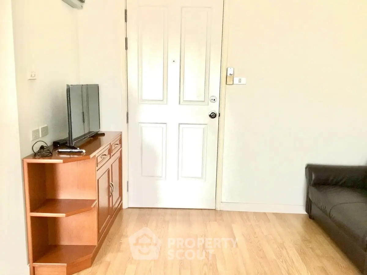 Cozy living room with wooden flooring and modern furniture in a bright apartment.