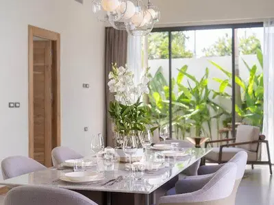 Elegant dining room with modern decor and garden view, perfect for entertaining.