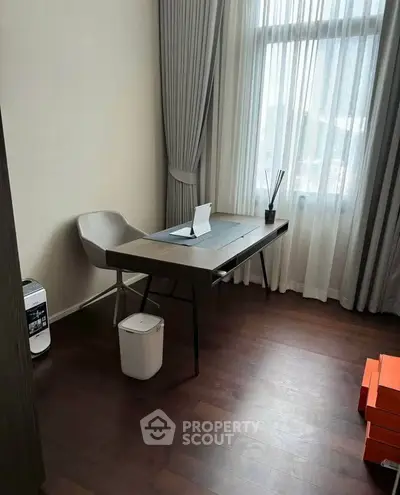 Modern study room with sleek desk and chair, featuring large window with elegant curtains.